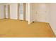 Spacious living room with natural light, carpet flooring, and a welcoming front entry door at 5825 Scalybark Rd, Durham, NC 27712