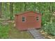 Well-maintained shed with a wooden ramp, providing extra storage space at 5825 Scalybark Rd, Durham, NC 27712