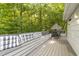Outdoor back porch features a built in cushioned seating area and table and chairs, perfect for entertaining and relaxation at 6125 Bellow St, Raleigh, NC 27609