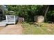 Backyard featuring a deck, a storage shed, and a partially wooded area at 6125 Bellow St, Raleigh, NC 27609