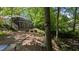 Beautiful backyard with a deck, patio, and wooded area, perfect for relaxation at 6125 Bellow St, Raleigh, NC 27609