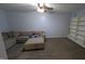 Basement living area with carpet, a comfortable sectional sofa, and a bookshelf at 6125 Bellow St, Raleigh, NC 27609