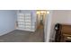 Finished basement hallway with a built-in bookshelf and carpet floors at 6125 Bellow St, Raleigh, NC 27609