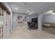 Finished basement with tile floors, a large bookcase, and walkout access to the backyard at 6125 Bellow St, Raleigh, NC 27609