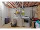 Unfinished basement with washer, dryer, and window providing natural light at 6125 Bellow St, Raleigh, NC 27609