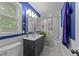 Stylish bathroom features a blue accent wall, large vanity, and nautical themed shower curtain at 6125 Bellow St, Raleigh, NC 27609