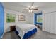 Inviting bedroom with two windows, closet, cozy bed with vibrant blue accents at 6125 Bellow St, Raleigh, NC 27609