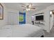 Spacious bedroom with large window, a closet, a wall-mounted TV, and neutral colors at 6125 Bellow St, Raleigh, NC 27609