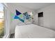 Comfortable bedroom featuring stylish accent wall, large window and neutral colors at 6125 Bellow St, Raleigh, NC 27609