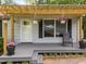 Charming covered front porch with decorative plants and a seating area; inviting entrance at 6125 Bellow St, Raleigh, NC 27609
