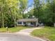 Charming single-story home with a welcoming front porch and lush landscaping at 6125 Bellow St, Raleigh, NC 27609