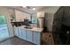Modern kitchen with white cabinets, stainless steel appliances and contemporary finishes at 6125 Bellow St, Raleigh, NC 27609