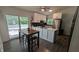 Bright kitchen with an island, stainless steel appliances, and a sliding glass door at 6125 Bellow St, Raleigh, NC 27609