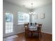 Charming dining room with hardwood floors, a chandelier, and elegant table setting at 637 Prickly Pear Dr, Fuquay Varina, NC 27526