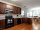 This kitchen features granite countertops and stainless steel appliances and opens to the dining area at 637 Prickly Pear Dr, Fuquay Varina, NC 27526