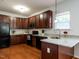 This kitchen features granite countertops, stainless steel appliances, and wood flooring at 637 Prickly Pear Dr, Fuquay Varina, NC 27526