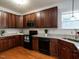 This kitchen features stainless steel appliances, granite countertops, and wood flooring at 637 Prickly Pear Dr, Fuquay Varina, NC 27526
