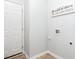 This laundry room features white walls, tiled flooring and a funny sign at 637 Prickly Pear Dr, Fuquay Varina, NC 27526