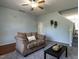 Cozy living room with comfortable sofa, modern decor, and access to staircase at 637 Prickly Pear Dr, Fuquay Varina, NC 27526