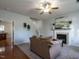 Comfortable living room with fireplace, neutral decor, and view to kitchen and staircase at 637 Prickly Pear Dr, Fuquay Varina, NC 27526