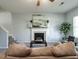 Bright living room with a decorative fireplace, ceiling fan, and comfortable seating at 637 Prickly Pear Dr, Fuquay Varina, NC 27526