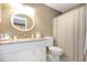 Bathroom featuring a vanity with granite countertop, oval mirror, and a toilet at 6922 Saxby Ct, Raleigh, NC 27613