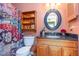 Cozy bathroom featuring granite countertops, floral shower curtain, and custom shelving unit at 6922 Saxby Ct, Raleigh, NC 27613