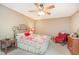 Bedroom with carpeted floors, decorative quilt, ceiling fan, and rocking chair at 6922 Saxby Ct, Raleigh, NC 27613