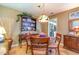 Cozy dining room with a round wooden table, vintage lighting, and a decorative china cabinet at 6922 Saxby Ct, Raleigh, NC 27613