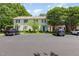 Exterior of townhomes showcasing well-maintained landscaping and ample parking in front of each unit at 6922 Saxby Ct, Raleigh, NC 27613