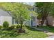 Quaint two-story home featuring light siding, green shutters, a well-kept lawn, and mature landscaping at 6922 Saxby Ct, Raleigh, NC 27613
