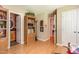 Hallway view with hardwood floors, showing open doorways to the bathroom and other rooms of the house at 6922 Saxby Ct, Raleigh, NC 27613