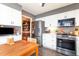 Updated kitchen features stainless steel appliances, granite counters, and white cabinetry at 6922 Saxby Ct, Raleigh, NC 27613