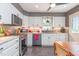 Bright kitchen featuring stainless appliances, undermount sink, granite countertops and white cabinetry at 6922 Saxby Ct, Raleigh, NC 27613
