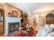 Comfortable living room featuring a fireplace with built-in shelving, hardwood floors, and cozy decor at 6922 Saxby Ct, Raleigh, NC 27613