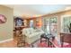 Inviting living area with hardwood flooring, a comfortable sofa, and large windows for natural light at 6922 Saxby Ct, Raleigh, NC 27613