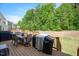 Open deck with dining and grilling space overlooking green space behind the home at 745 Orange Oak Ln, Apex, NC 27523