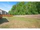 Large, well-maintained back yard with wooded border at 745 Orange Oak Ln, Apex, NC 27523