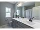 Bright bathroom featuring double sink vanity with white countertops and a shower-tub combo at 745 Orange Oak Ln, Apex, NC 27523