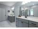 Bright bathroom features double vanity, white countertops, and a walk-in shower with black trim at 745 Orange Oak Ln, Apex, NC 27523