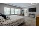 Large, naturally lit bedroom with plush carpet, a TV, and a view into the Primary bathroom at 745 Orange Oak Ln, Apex, NC 27523