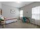 Bright bedroom with carpet flooring, desk and natural light from the large windows at 745 Orange Oak Ln, Apex, NC 27523
