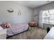 Bright bedroom with carpet flooring, decor, comfortable furnishings, and natural light from the window at 745 Orange Oak Ln, Apex, NC 27523