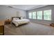 Bright bedroom with large windows, a comfortable bed, and neutral decor at 745 Orange Oak Ln, Apex, NC 27523