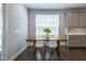 This dining area has a wooden table with modern white chairs and view of backyard at 745 Orange Oak Ln, Apex, NC 27523