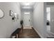 Bright entryway features hardwood floors, decorative mirrors, and a bench, creating a welcoming space at 745 Orange Oak Ln, Apex, NC 27523