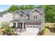 Charming two-story home with a landscaped front yard and inviting front porch, plus a two car garage at 745 Orange Oak Ln, Apex, NC 27523