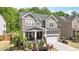 Charming two-story home with a landscaped front yard and inviting front porch, plus a two car garage at 745 Orange Oak Ln, Apex, NC 27523