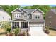 Charming two-story home with a landscaped front yard and inviting front porch, plus a two car garage at 745 Orange Oak Ln, Apex, NC 27523