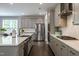 Well-equipped kitchen with stainless steel appliances, gray cabinetry, and a functional layout at 745 Orange Oak Ln, Apex, NC 27523